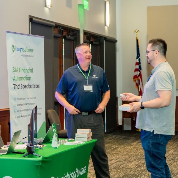 conference sponsors speak with attendee